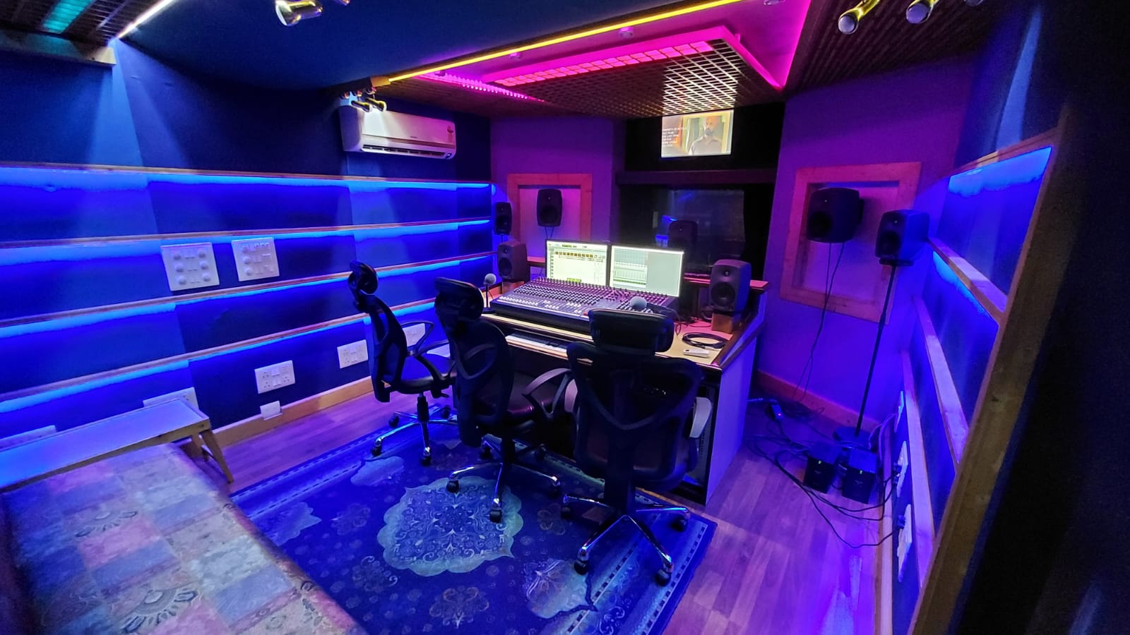 Divine Digital Studio control room illuminated in blue and magenta
